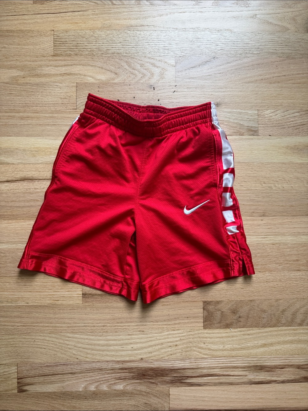 Nike Red Athletic Shorts with White Swoosh and Side Panels